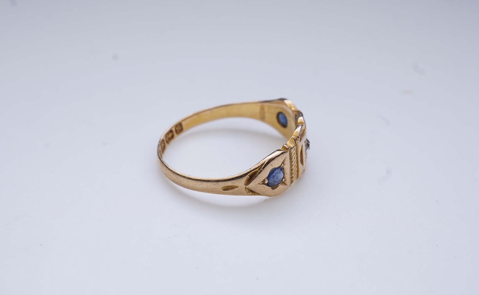 A Victorian sapphire and diamond three-stone ring, circa 1892